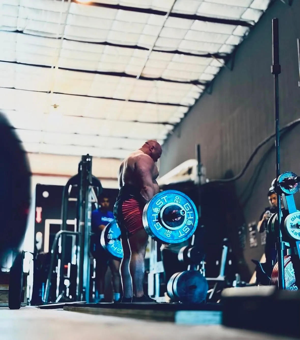 A lifter setting up over a loaded deadlift bar